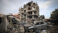 File: Palestinians inspect the damage at the Al-Maghazi refugee camp after an overnight Israeli strike on December 25, 2023. (Photo by Mahmud Hams / AFP)
