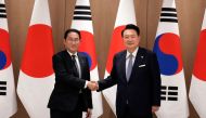 South Korea's President Yoon Suk Yeol (R) and Japan's Prime Minister Fumio Kishida shake hands during a meeting at the Presidential Office in Seoul on September 6, 2024. (Photo by Lee Jin-man / POOL / AFP)