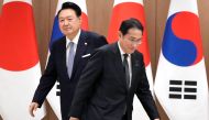 South Korean President Yoon Suk Yeol (L) and Japanese Prime Minister Fumio Kishida walk to their chairs during a meeting at the Presidential Office in Seoul on September 6, 2024. Photo by Lee Jin-man / POOL / AFP.