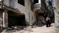 Residents walk amid the destruction following an Israeli military raid in the Jenin refugee camp, in the occupied West Bank on September 6, 2024. (Photo by Ronaldo Schemidt / AFP)