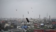 Debris flies in the air as heavy rain and high winds from Super Typhoon Yagi impact Hai Phong on September 7, 2024. (Photo by NHAC NGUYEN / AFP)