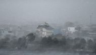 Water is whipped up by high winds onto the shore of Phuong Luu lake as Super Typhoon Yagi hits Hai Phong on September 7, 2024. Photo by NHAC NGUYEN / AFP.