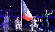 France's Aurelie Aubert (2nd L) and France's Tanguy De La Forest (2nd R) parade on stage during the Paris 2024 Paralympic Games Closing Ceremony at the Stade de France, in Saint-Denis, in the outskirts of Paris, on September 8, 2024. (Photo by Thibaud Moritz / AFP)