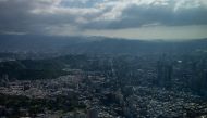 Photo used for demonstration purposes. Sunlight shines through clouds above Taipei, as seen from the 508-meter Taipei 101 skyscraper on September 3, 2024. Photo by Yan ZHAO / AFP.