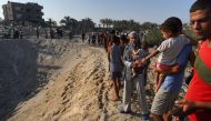 Palestinians inspect the damage at the site of Israeli strikes on a makeshift displacement camp in Mawasi Khan Yunis in the Gaza Strip on September 10, 2024. Photo by Bashar TALEB / AFP.