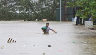 A man walks through flood waters in Hanoi on September 11, 2024, in the aftermath of Typhoon Yagi hitting northern Vietnam. (Photo by NHAC NGUYEN / AFP)
 