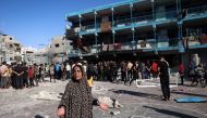 A Palestinian woman gestures at the courtyard of a school after an Israeli air strike hit the site, in Nuseirat in the central Gaza Strip on September 11, 2024. (Photo by Eyad Baba / AFP)