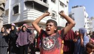 A Palestinian boy reacts at the site of an Israeli strike in the Shejaiya suburb east of Gaza City on September 12, 2024. (Photo by Omar Al-Qattaa/ AFP)

