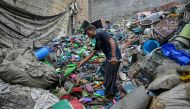  A worker sorts plastic objects at a recycling unit in Karachi on September 10, 2024. (Photo by Asif Hassan / AFP)
