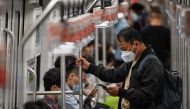 People commute on a train in Shanghai on September 20, 2022. Photo by Hector RETAMAL / AFP