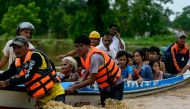 Flood-affected residents are transported on a rescue boat in Taungoo, Myanmar's Bago region on September 14, 2024. (Photo by Sai Aung MAIN / AFP)