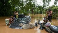 Flood-affected residents wait for a rescue boat to arrive in Taungoo, Myanmar's Bago region on September 14, 2024, following heavy rains in the aftermath of Typhoon Yagi. Photo by Sai Aung MAIN / AFP.