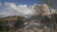 Responders put out a fire in the area of Lod, near Tel Aviv on September 15, 2024. Photo by Menahem KAHANA / AFP.