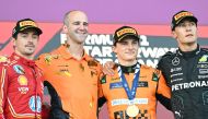 Second placed Ferrari's Monegasque driver Charles Leclerc, winner McLaren's Australian driver Oscar Piastri and third placed Mercedes' British driver George Russell celebrate on the podium after the Formula One Azerbaijan Grand Prix at the Baku City Circuit in Baku on September 15, 2024. Photo by Natalia KOLESNIKOVA / AFP.