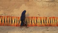 An Afghan burqa-clad woman walks along a street in Fayzabad district of Badakhshan Province on September 16, 2024. (Photo by Omer Abrar / AFP)