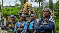 In this photograph taken on September 2, 2024, tea pickers listen to Palani Shakthivel, national organiser of the Ceylon Workers Congress (CWC), at a village in Hatton. Photo by Ishara S. KODIKARA / AFP.