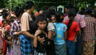 Flood-affected residents line up for food at a temporary camp set up at a monastery in Taungoo, Myanmar's Bago region on September 14, 2024. Photo by Sai Aung MAIN / AFP.