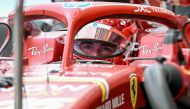 Ferrari's Monegasque driver Charles Leclerc looks on as team mechanics work on his car during the first practice session ahead of the Formula One Singapore Grand Prix night race at the Marina Bay Street Circuit in Singapore on September 20, 2024. (Photo by Lillian SUWANRUMPHA / AFP)