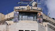 Pictures of slain al-Jazeera journalist Shireen Abu Akleh hang on the facade of the building housing the television station's office in Ramallah in the occupied West Bank. (Photo by Jaafar Ashtiyeh / AFP)
 