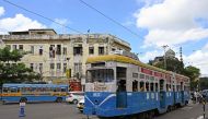 In this photo taken on September 8, 2024, passengers commute in a tram along a street in Kolkata. (Photo by Dibyangshu Sarkar / AFP) 