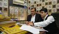 In this photograph taken on September 6, 2024, lawyers go through a case file inside their chamber at the court complex in Ghaziabad. (Photo by Money Sharma / AFP) 