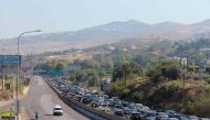 Vehicles wait in traffic in the town of Damour, south of the capital Beirut on September 24, 2024, as people flee southern Lebanon. (Photo by Ibrahim Amro / AFP)