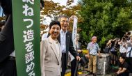 Hideko Hakamada (C), sister of Iwao Hakamada (not pictured), and lawyers pose with a white banner (R) reading 