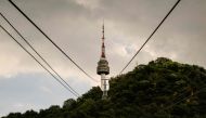 A general view taken from the Hoehyeon-dong platform shows the Namsan Tower and cables for the Namsan cable car in Seoul on September 25, 2024. (Photo by ANTHONY WALLACE / AFP)