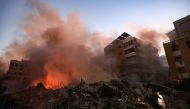 Smoke rises from the smouldering rubble at the scene of Israeli air strikes in the Haret Hreik neighbourhood of Beirut's southern suburbs on September 27, 2024. (Photo by Ibrahim AMRO / AFP)
