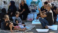 People who fled Israeli bombardment on Beirut's southern suburbs, gather in the Lebanese capital's downtown district where they spent the night, on September 28, 2024. Photo by JOSEPH EID / AFP.