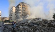 A man walks through the rubble as people check on September 28, 2024 the devastation in the Hadath neighbourhood of Beirut's southern suburbs in the aftermath of overnight Israeli airstrikes on the outskirts of the Lebanese capital. (Photo by AFP)
