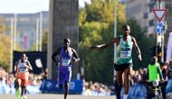 Ethiopia's Milkesa Mengesha (R) competes ahead of Kenya's Cybrian Kotut (C) and Ethiopia's Haymanot Alew to win the 50th edition of the Berlin Marathon in Berlin, Germany on September 29, 2024. (Photo by John MACDOUGALL / AFP)
