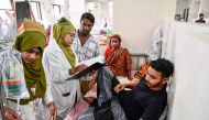 A dengue patient receives treatment at a hospital in Dhaka on September 28, 2024. (Photo by Munir UZ ZAMAN / AFP)
