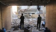 People inspect the damage at the site of an overnight Israeli strike on Beirut's southern suburb of Ghobeiry on September 30, 2024. (Photo by AFP)