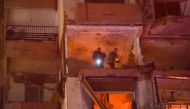 Firefighters search for survivors inside an apartment building hit by an Israeli air strike in Beirut's Cola district, September 30, 2024. Photo by Fadel ITANI / AFP.