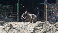 Vendors clear mud from a vegetable market in a flood-affected area following heavy monsoon rains in Kathmandu on September 30, 2024. Photo by Prakash MATHEMA / AFP