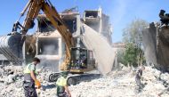 Civil defence workers dig through the rubble of a building at the site of an overnight Israeli airstrike that targeted a neighbourhood in the eastern city of Baalbek on September 30, 2024. (Photo by AFP)
