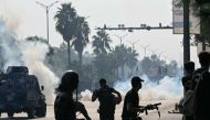 Policemen fire tear gas shells to disperse supporters of jailed former prime minister Imran Khan's Pakistan Tehreek-e-Insaf (PTI) party during a protest in Islamabad on October 5, 2024. (Photo by FAROOQ NAEEM / AFP)
