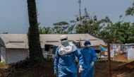 Two workers from the NGO Alima walk in the courtyard of the mpox treatment centre in Kamituga, South Kivu in the east of the Democratic Republic of Congo on September 20, 2024. Photo by Glody MURHABAZI / AFP.