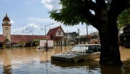 A car is submerged in flood waters in front of the central train station in Chiang Mai, on October 6, 2024. (Photo by AFP)
