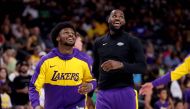 Bronny James #9 and LeBron James #23 of the Los Angeles Lakers warm up prior to the game against the Phoenix Suns on October 06, 2024 in Palm Springs, California. Katelyn Mulcahy/Getty Images/AFP 