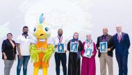 A group of Doha Academy teachers and staff with a mascot on the occasion.