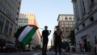 Photo used for demonstration purposes. A demonstrator holds a Palestinian flag as people march to mark one year of the war on Gaza, in Washington, DC on October 5, 2024. Photo by Ting Shen / AFP.
