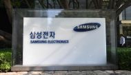 A man walks past a signboard of Samsung Electronics outside the company's Seocho building in Seoul on October 8, 2024. Photo by Jung Yeon-je / AFP