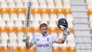 England's Joe Root celebrates after scoring a century (100 runs) during the third day of the first Test cricket match between Pakistan and England at the Multan Cricket Stadium in Multan on October 9, 2024. (Photo by Aamir Qureshi / AFP)
 