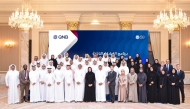 QNB officials pose for a photo with participants during the program.