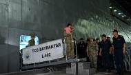 A Turkish soldier holds a child evacuee as Turkish citizens evacuated from Lebanon disembark from the TCG L402 Bayreaktar Turkish war ship after its arrival at the southern Turkish port of Mersin, southern Turkey, on October 10, 2024. (Photo by Ozan Kose / AFP)