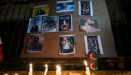 Cubans light candles next to pictures of late reggaeton singer Jose Manuel Carbajal (El Taiger) as they pay tribute in Havana on October 10, 2024. Photo by YAMIL LAGE / AFP