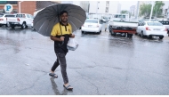 A pedestrian carrying an umbrella to protect himself from the rainfall in Doha, Qatar, on Friday October 11, 2024. Photo by Rajan Vadakkemuriyil / The Peninsula