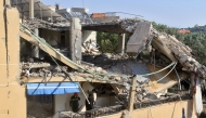 Photo used for demonstration purposes. First responders stand on the balcony of an apartment building that was targeted in an Israeli airstrike in the village of Wardaniye, south of Beirut on October 9, 2024. Photo by Mahmoud ZAYYAT / AFP.
